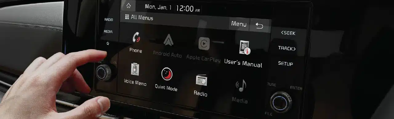 Kia Carnival infotainment touchscreen being operated