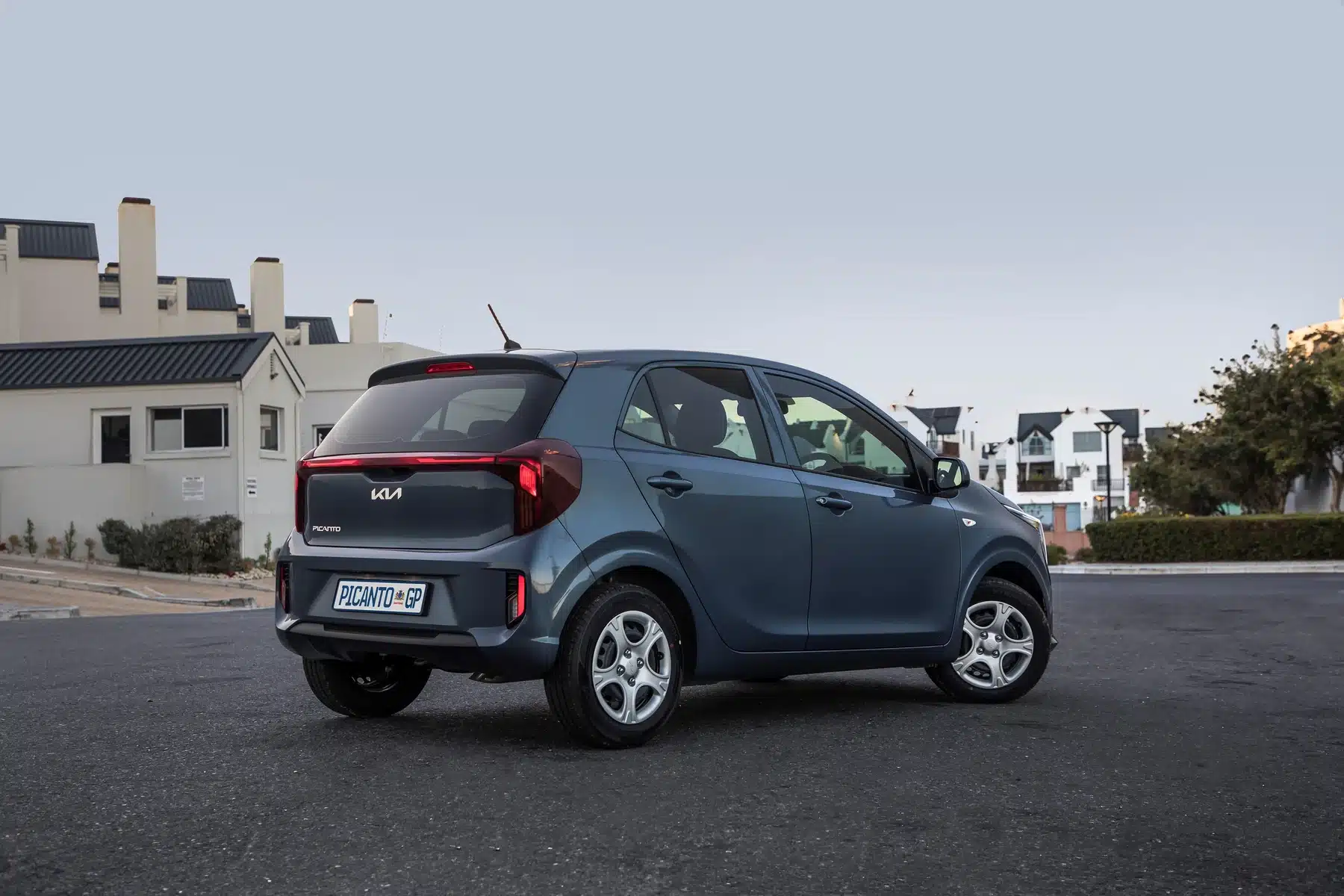 Blue Kia Picanto rear three-quarter view on a town street