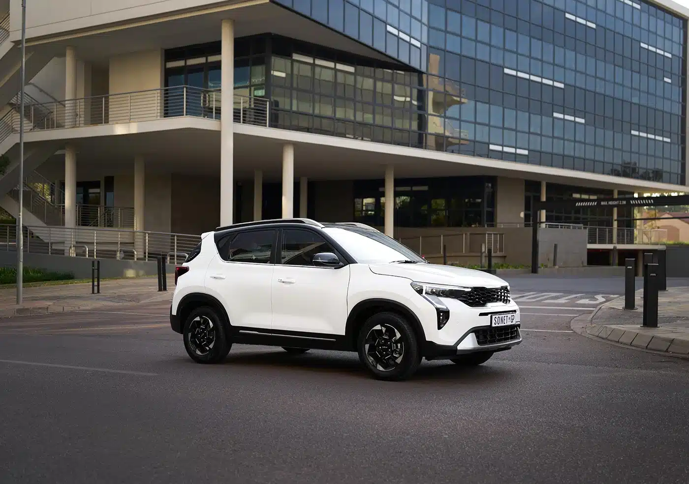 White Kia Sonet on an urban street