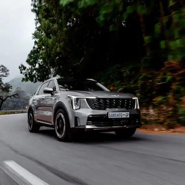 Kia Sorento driving along a tree-lined road
