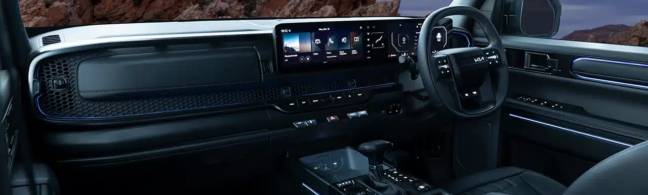Wide dashboard and centre console inside the Kia Tasman